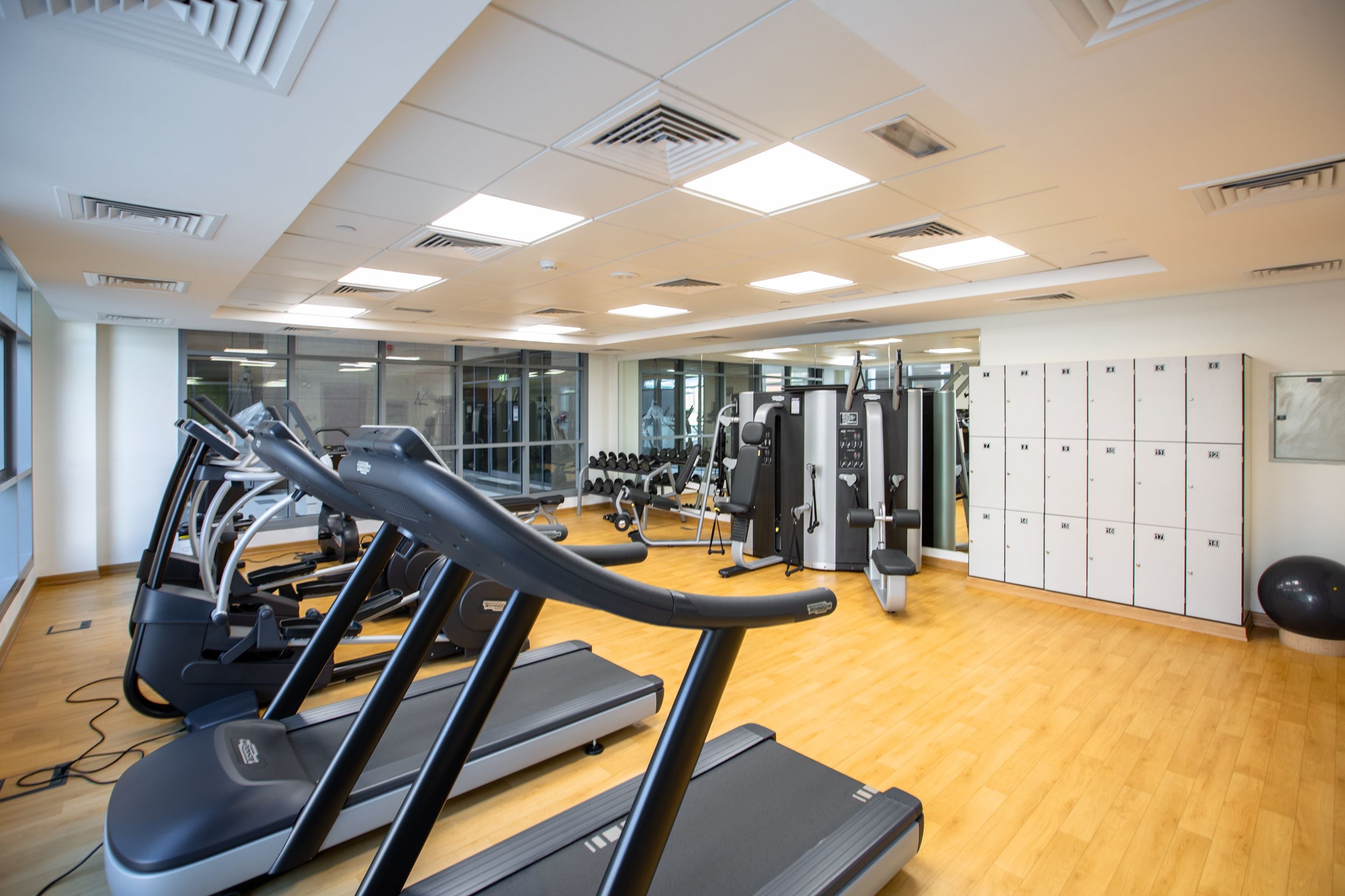 Residential gym with treadmills, fitness machines and lockers