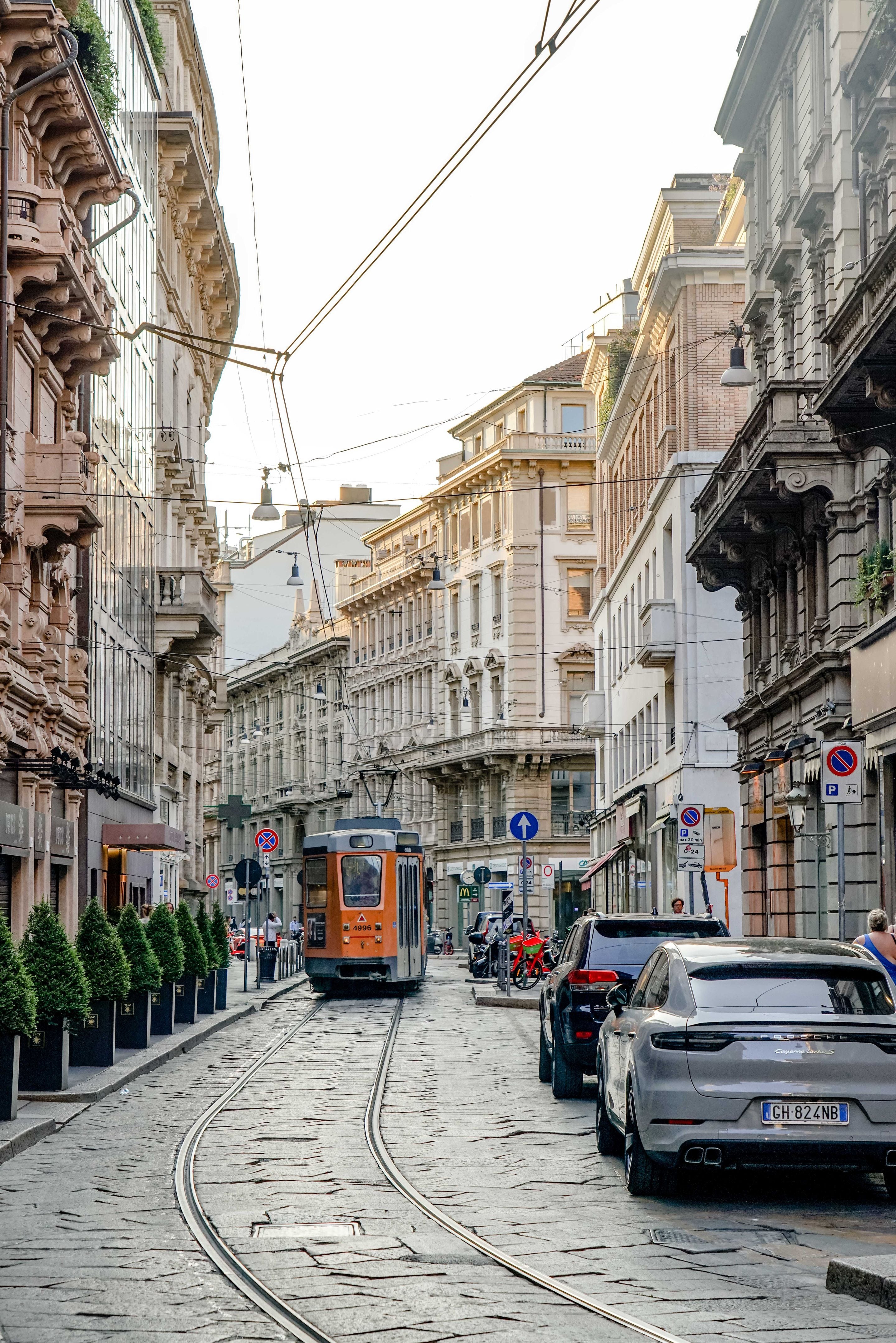 Tram on Via Torino lined with historic Milan apartment buildings