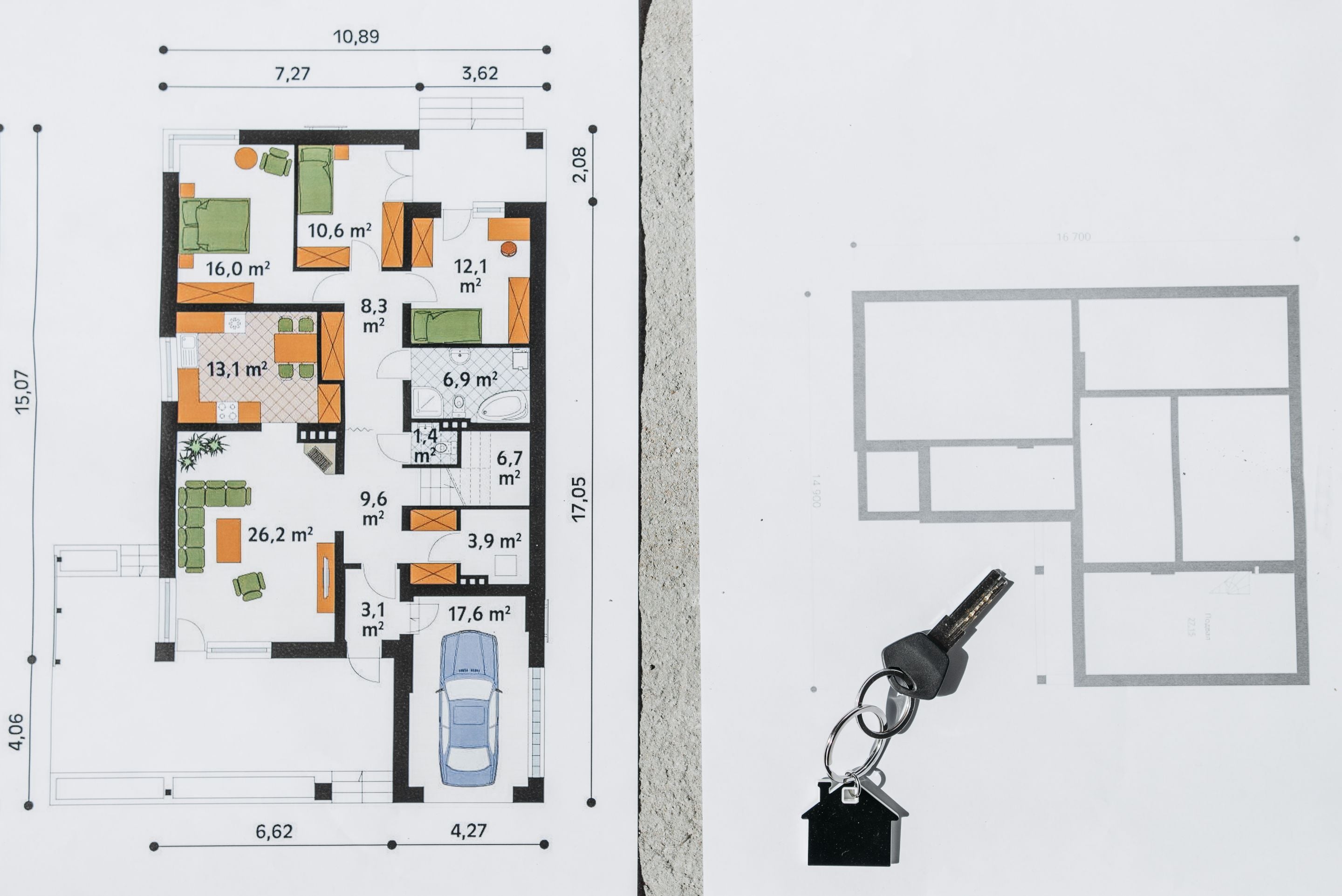 Colour house floor plan with room areas and a garage beside a house keyring